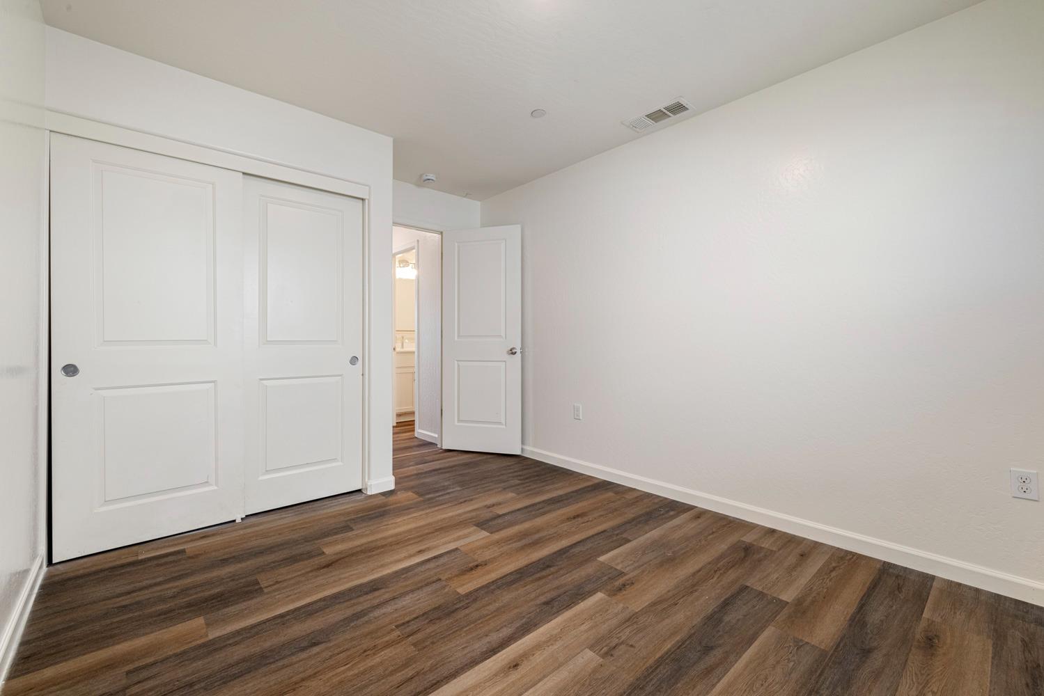 342 Rubicon Court Merced, CA 95341 - Photo 26 of 40 a view of an empty room with wooden floor