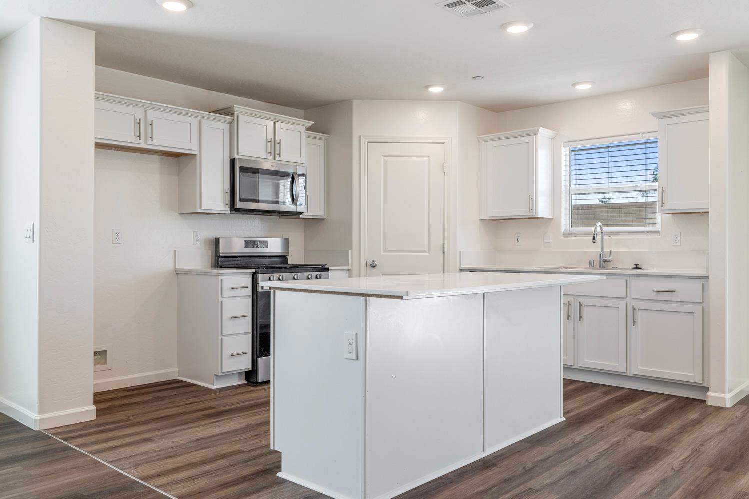 342 Rubicon Court Merced, CA 95341 - Photo 27 of 40 a kitchen with cabinets appliances a sink and a counter top space