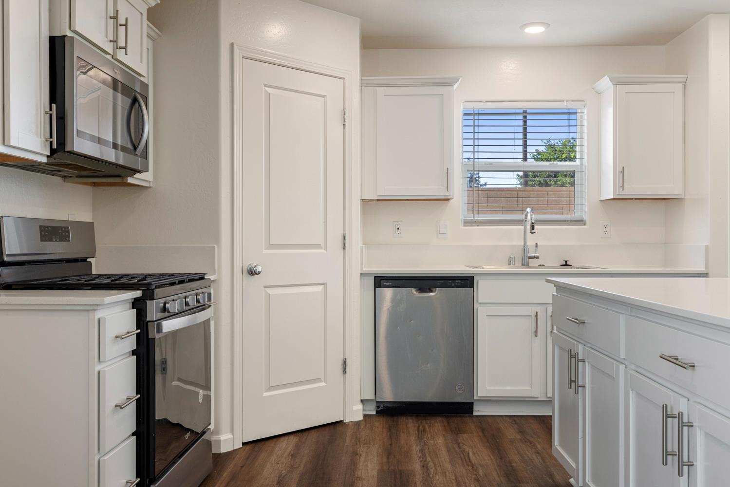 342 Rubicon Court Merced, CA 95341 - Photo 28 of 40 a kitchen with stainless steel appliances granite countertop a sink a stove and cabinets