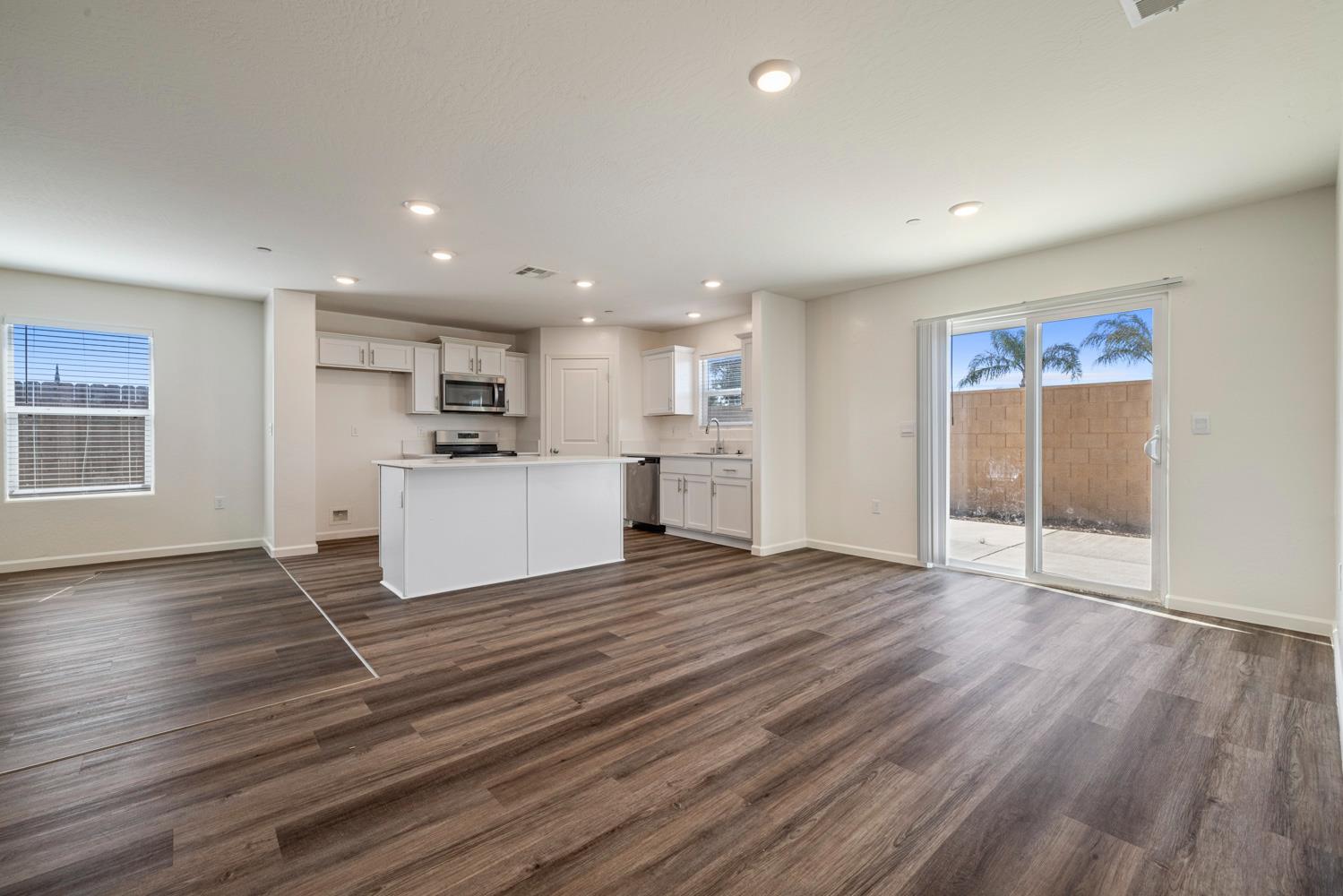342 Rubicon Court Merced, CA 95341 - Photo 31 of 40 a view of a kitchen with wooden floor and a window