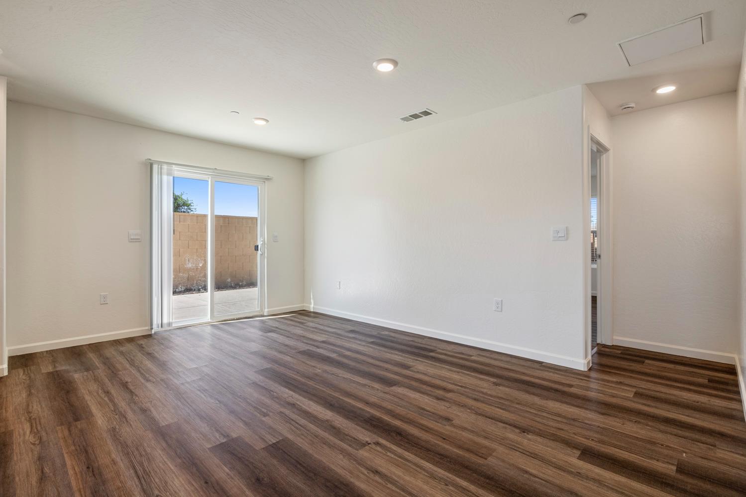 342 Rubicon Court Merced, CA 95341 - Photo 32 of 40 a view of an empty room with wooden floor and a window
