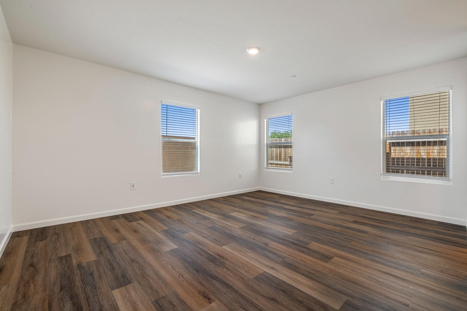 342 Rubicon Court Merced, CA 95341 - Photo 33 of 40 a view of an empty room with wooden floor and a window