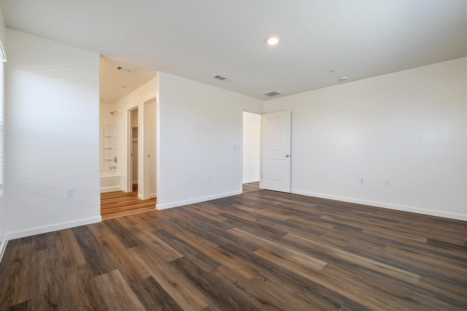342 Rubicon Court Merced, CA 95341 - Photo 34 of 40 a view of an empty room with wooden floor