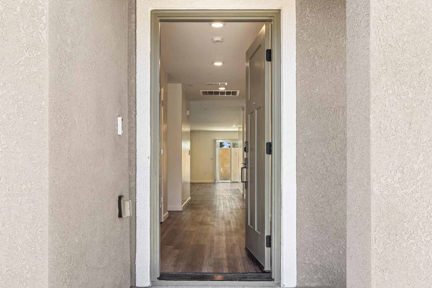 342 Rubicon Court Merced, CA 95341 - Photo 4 of 40 a view of a hallway with wooden floor and living room