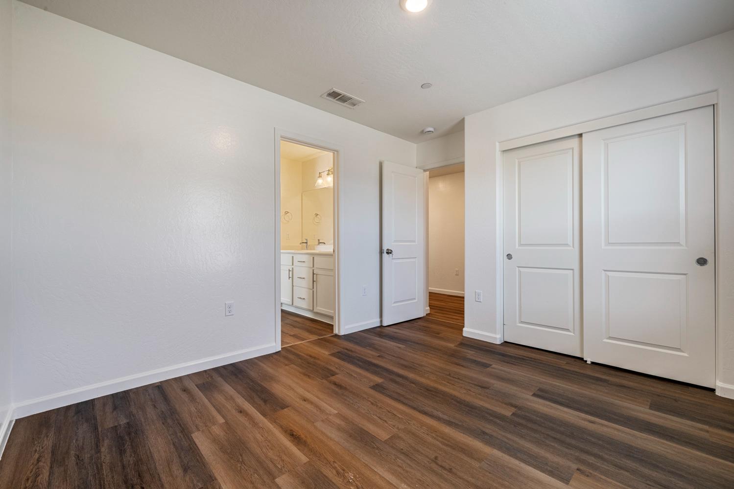 342 Rubicon Court Merced, CA 95341 - Photo 8 of 40 a view of empty room with wooden floor