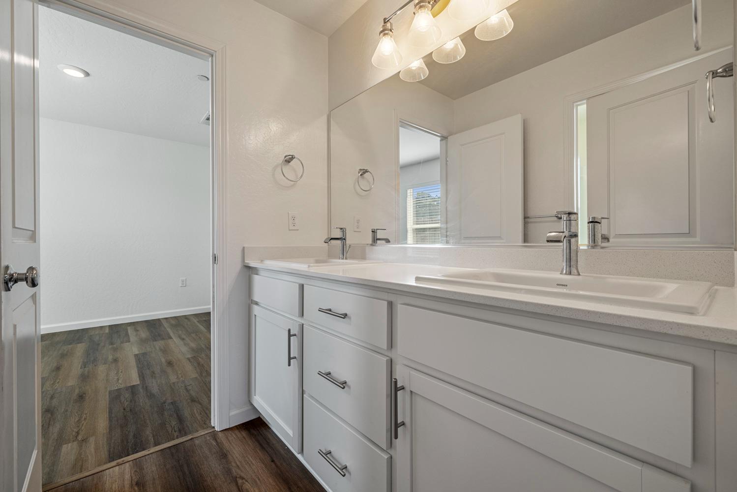 342 Rubicon Court Merced, CA 95341 - Photo 9 of 40 a bathroom with a double vanity sink and a mirror