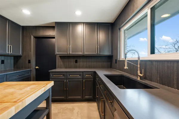 a kitchen that has a sink and a stove