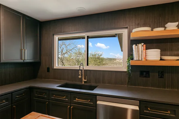 a kitchen with a sink and large window