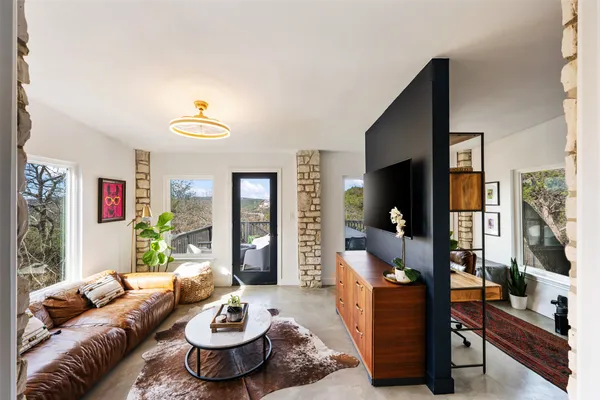 a living room with furniture and a wooden floor