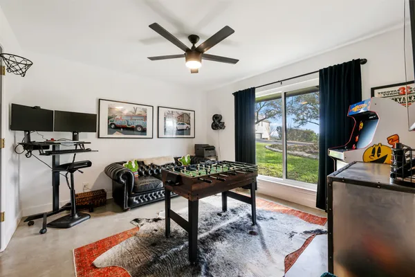 a living room with furniture a flat screen tv and a large window