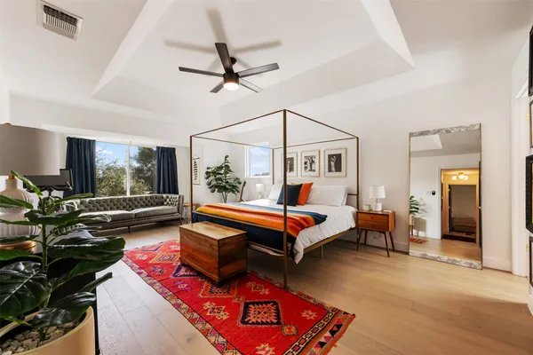 a bedroom with a bed and wooden floor