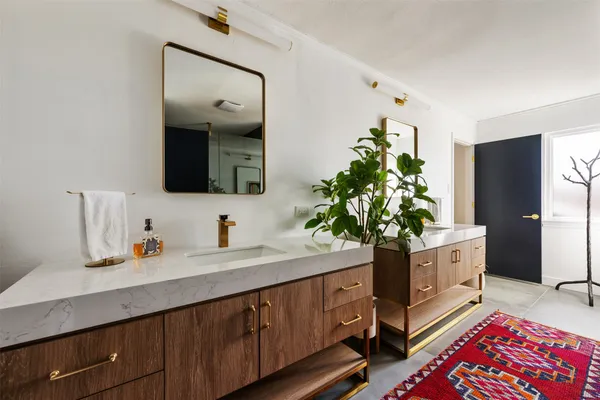 a spacious bathroom with a double vanity sink and a large mirror