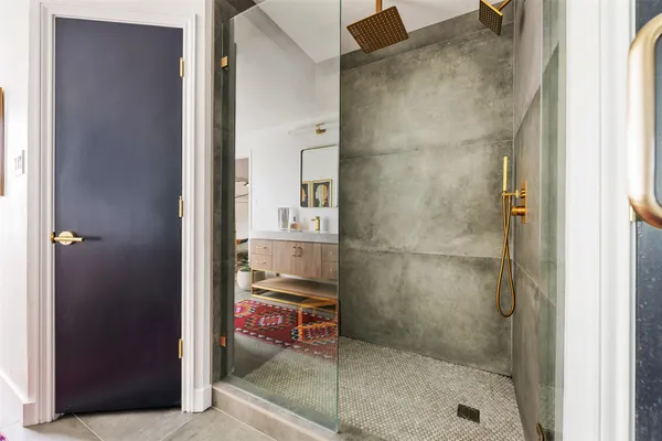 a bathroom with a potted plant and a shower