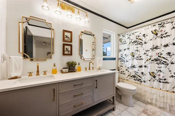 a bedroom with a bed mirror furniture and a window