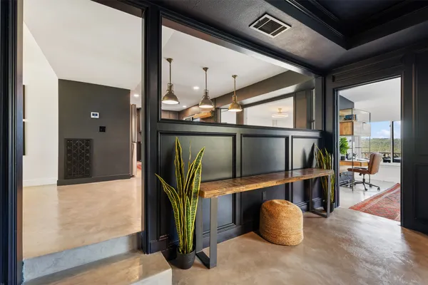 a living room with furniture and a floor to ceiling window