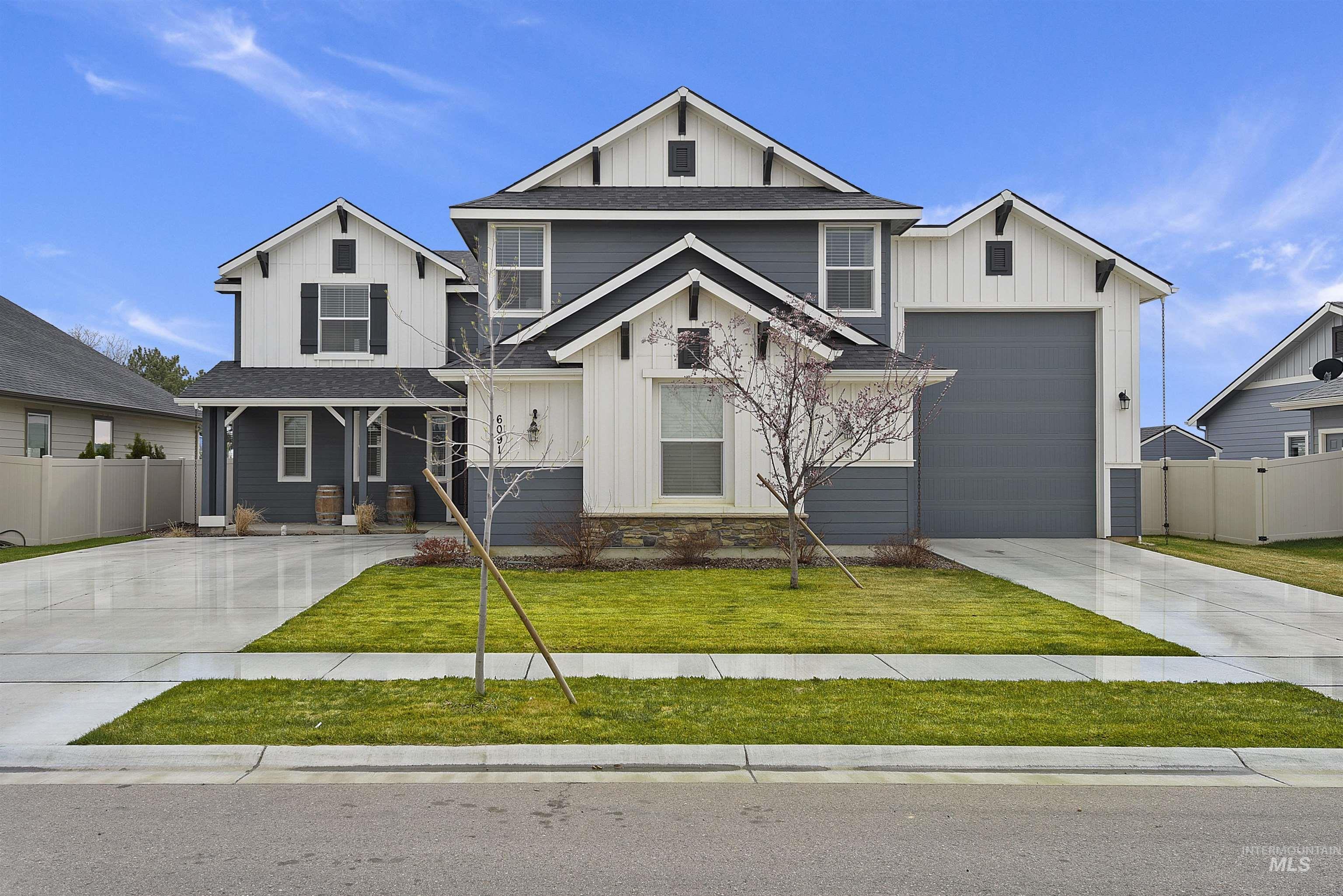 6091 East Path Drive Nampa, ID 83687 - Photo 1 of 33 View of front facade featuring board and batten siding, driveway, covered porch, and roof with shingles