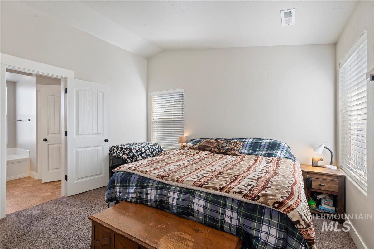 6091 East Path Drive Nampa, ID 83687 - Photo 16 of 33 Bedroom with carpet, multiple windows, and vaulted ceiling