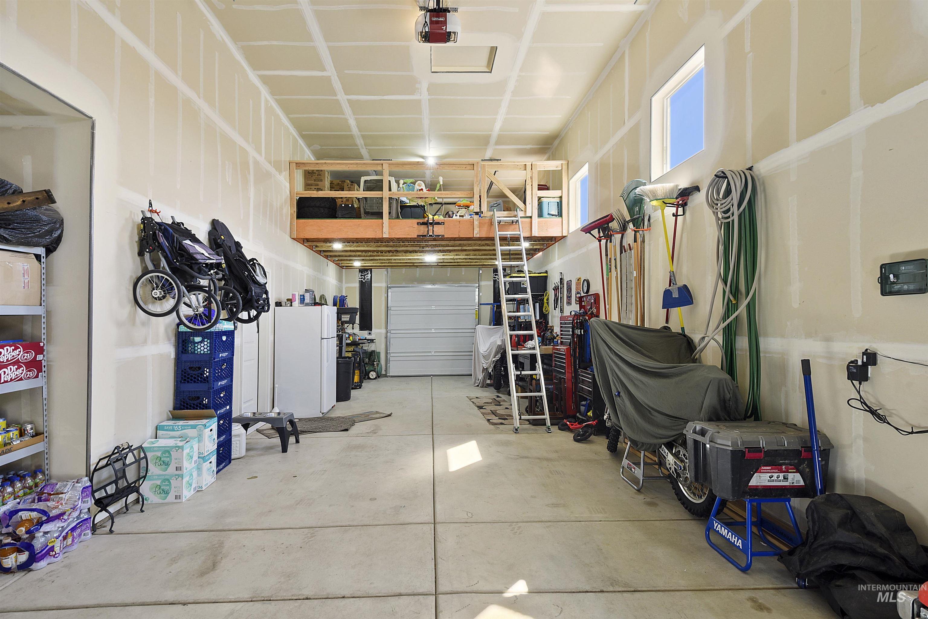 6091 East Path Drive Nampa, ID 83687 - Photo 27 of 33 Garage with freestanding refrigerator and a garage door opener