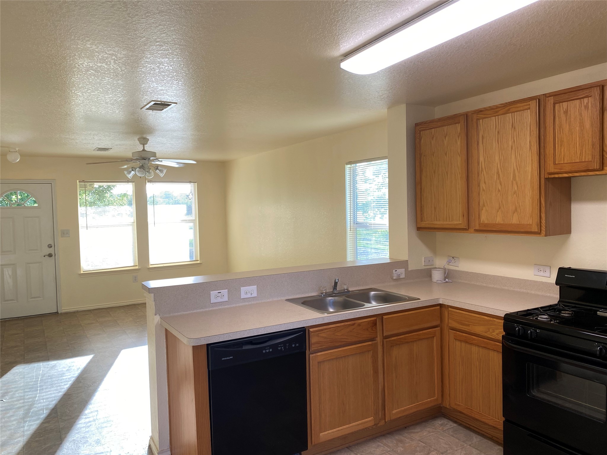 13023 Pleasant Valley Drive Rosharon, TX 77583 - Photo 6 of 21 a kitchen with sink cabinets and window