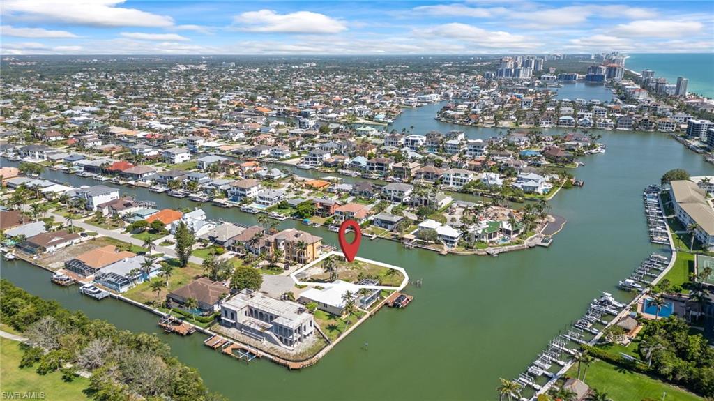 140 Flamingo Avenue Naples, FL 34108 - Photo 22 of 25 an aerial view of a city with lots of residential buildings ocean and mountain view in back