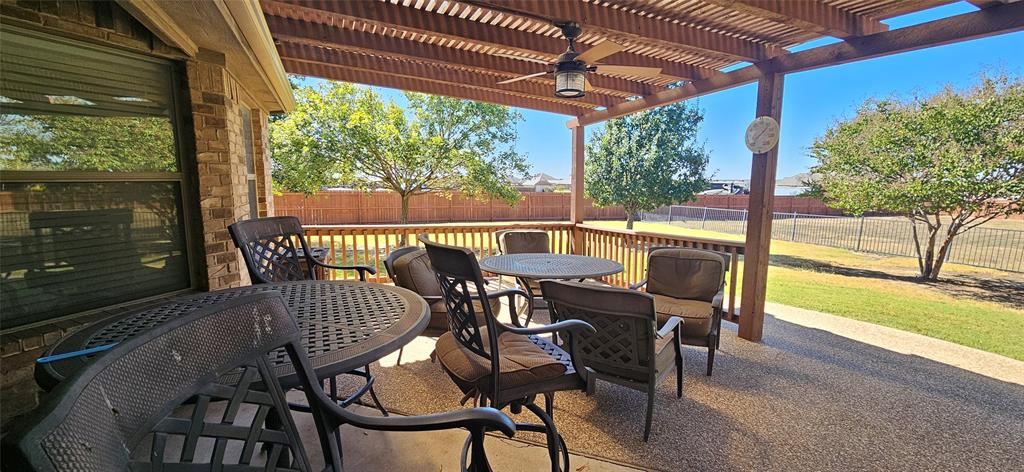 7641 Drew Lane Midlothian, TX 76065 - Photo 10 of 13 a view of a patio with a table chairs and a grill