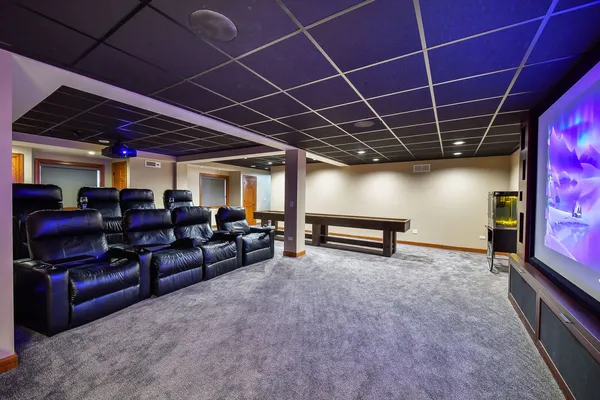 a media room with lots of chairs and a projector