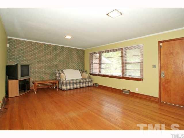3114 Dixon Road Durham, NC 27707 - Photo 4 of 11 Very large living room with wood floors and big picture window.