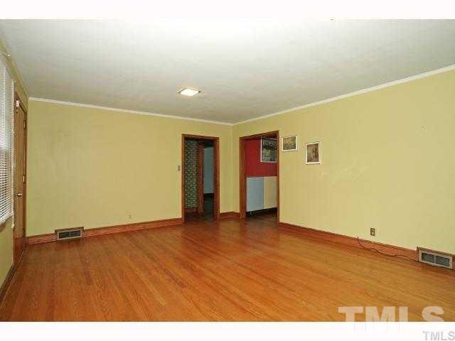 3114 Dixon Road Durham, NC 27707 - Photo 5 of 11 Very large living room with wood floors and big picture window.