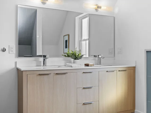 a bathroom with a double vanity sink and a mirror