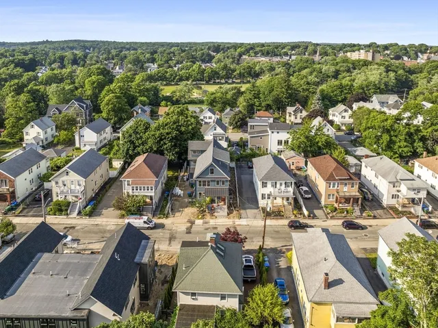 an aerial view of residential houses with outdoor space