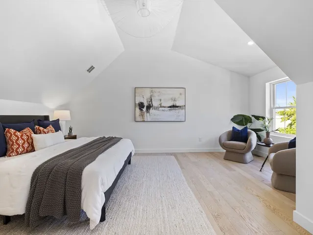 a bedroom with a bed and a couch