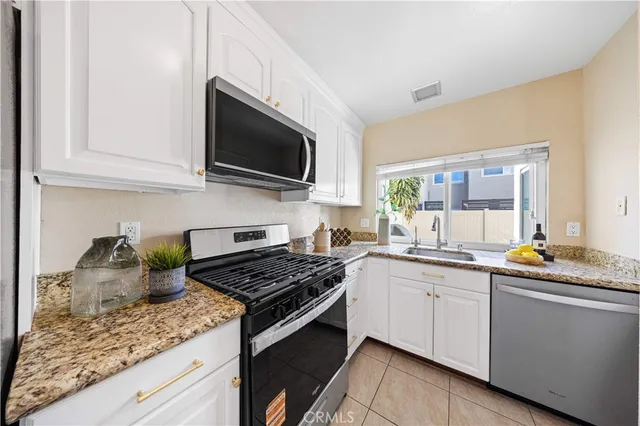 a kitchen with a sink stove top oven and microwave