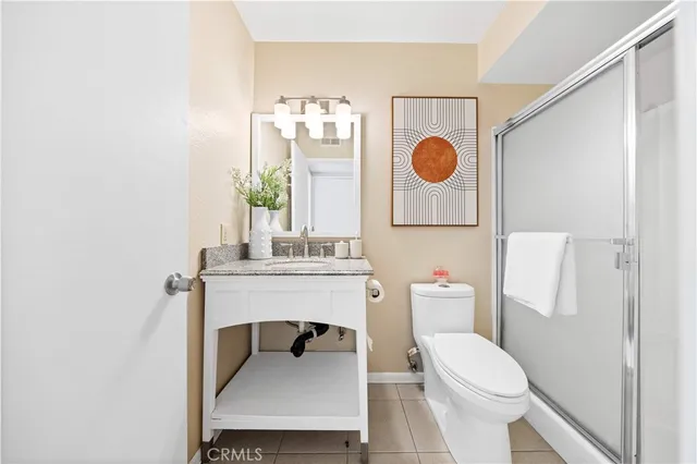 a bathroom with a toilet a sink and a mirror
