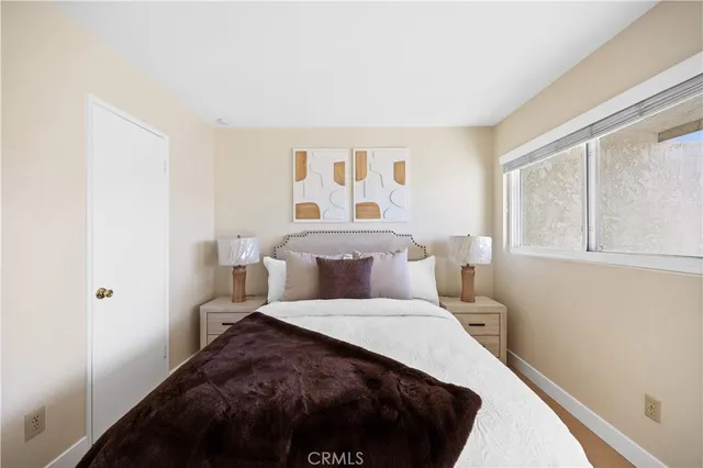 a bedroom with a large bed and a window