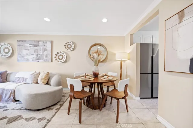 a living room with furniture a clock and a refrigerator