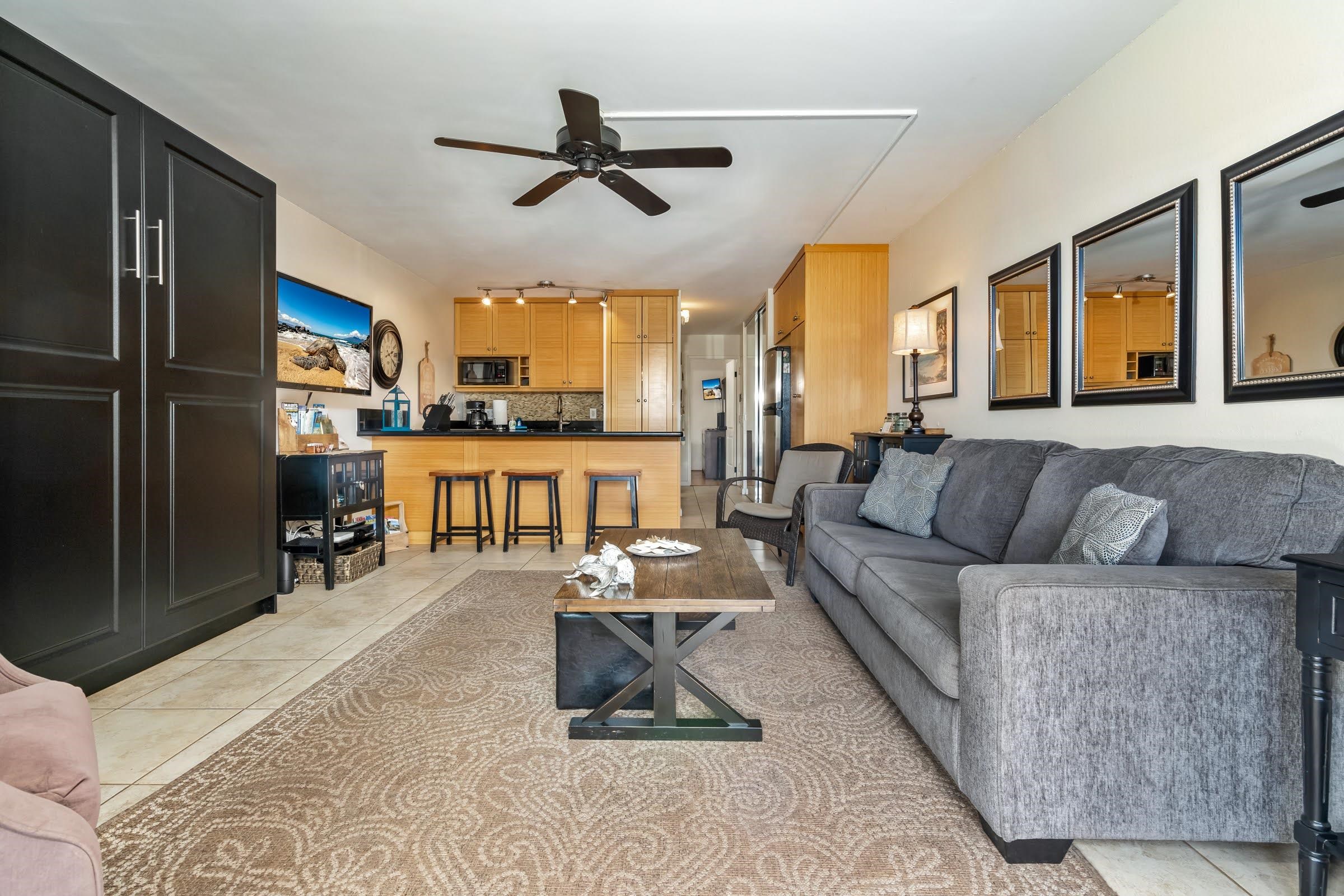 2191 South Kihei Road, Unit 1110 Kihei, HI 96753 - Photo 1 of 20 a living room with furniture and a flat screen tv