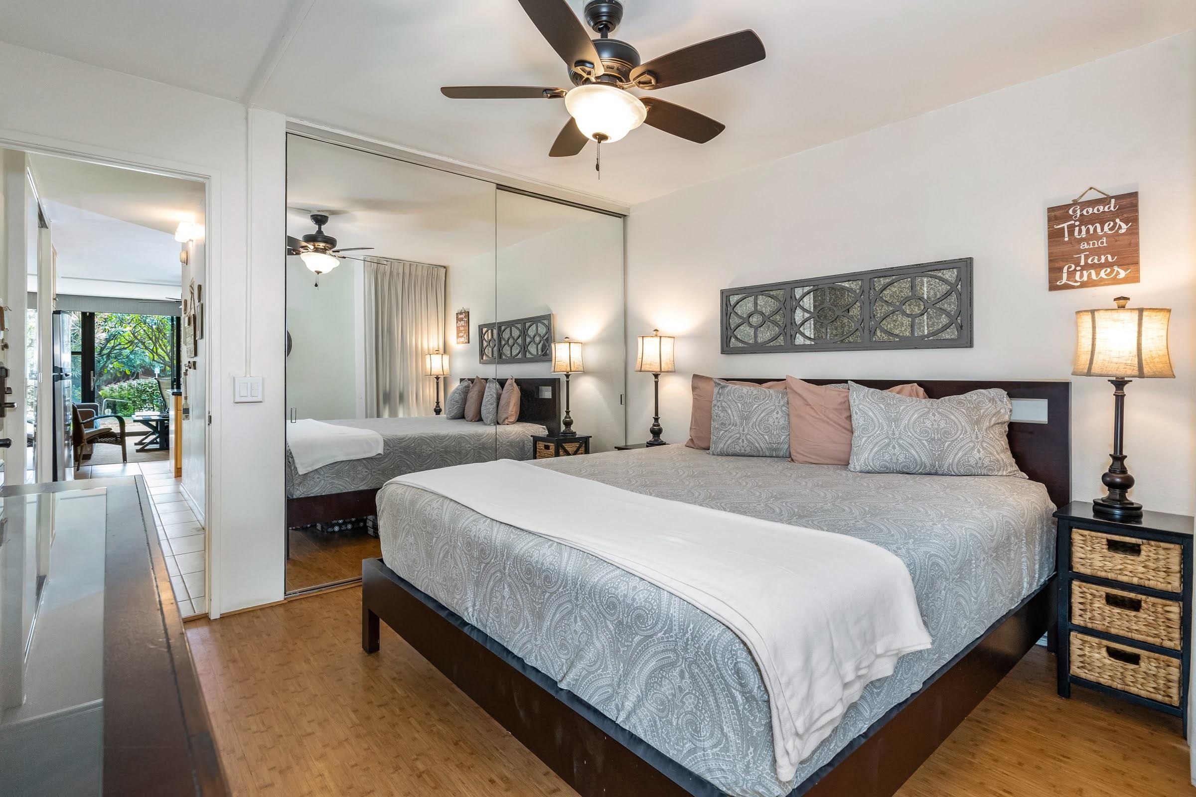 2191 South Kihei Road, Unit 1110 Kihei, HI 96753 - Photo 11 of 20 a bedroom with bed and a chandelier