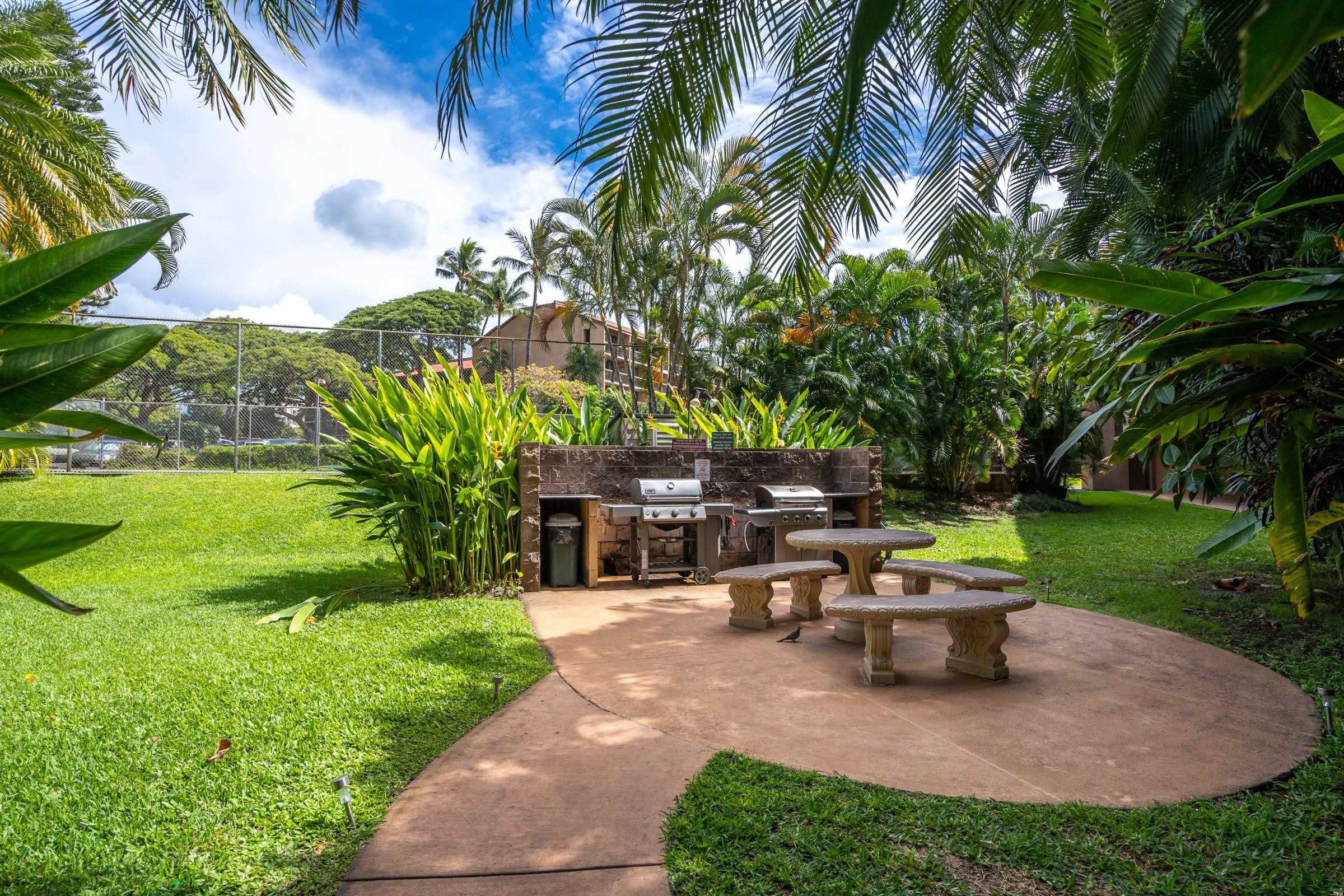 2191 South Kihei Road, Unit 1110 Kihei, HI 96753 - Photo 13 of 20 a view of a patio with table and chairs potted plants and palm tree