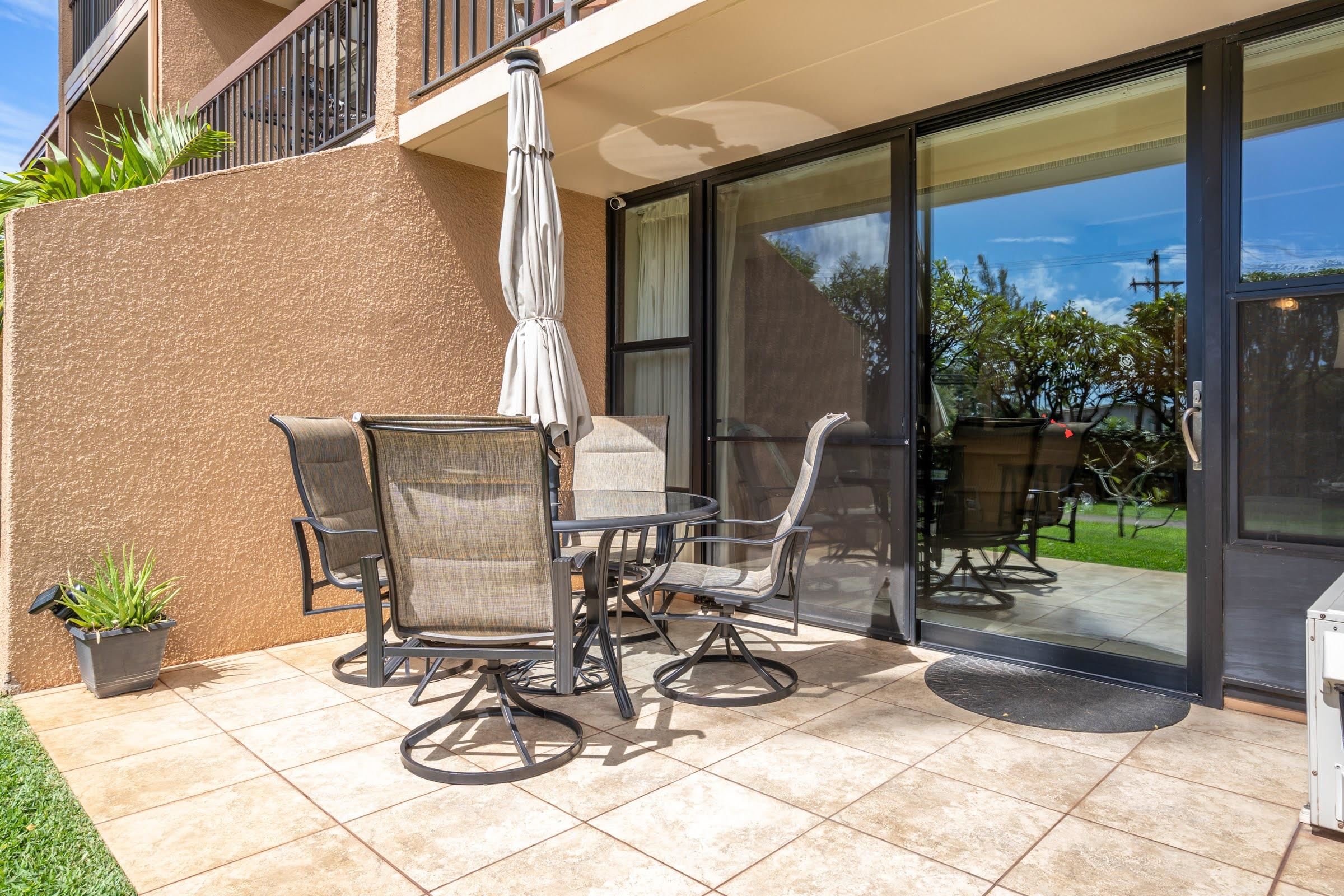 2191 South Kihei Road, Unit 1110 Kihei, HI 96753 - Photo 15 of 20 a view of a patio with table and chairs and potted plants