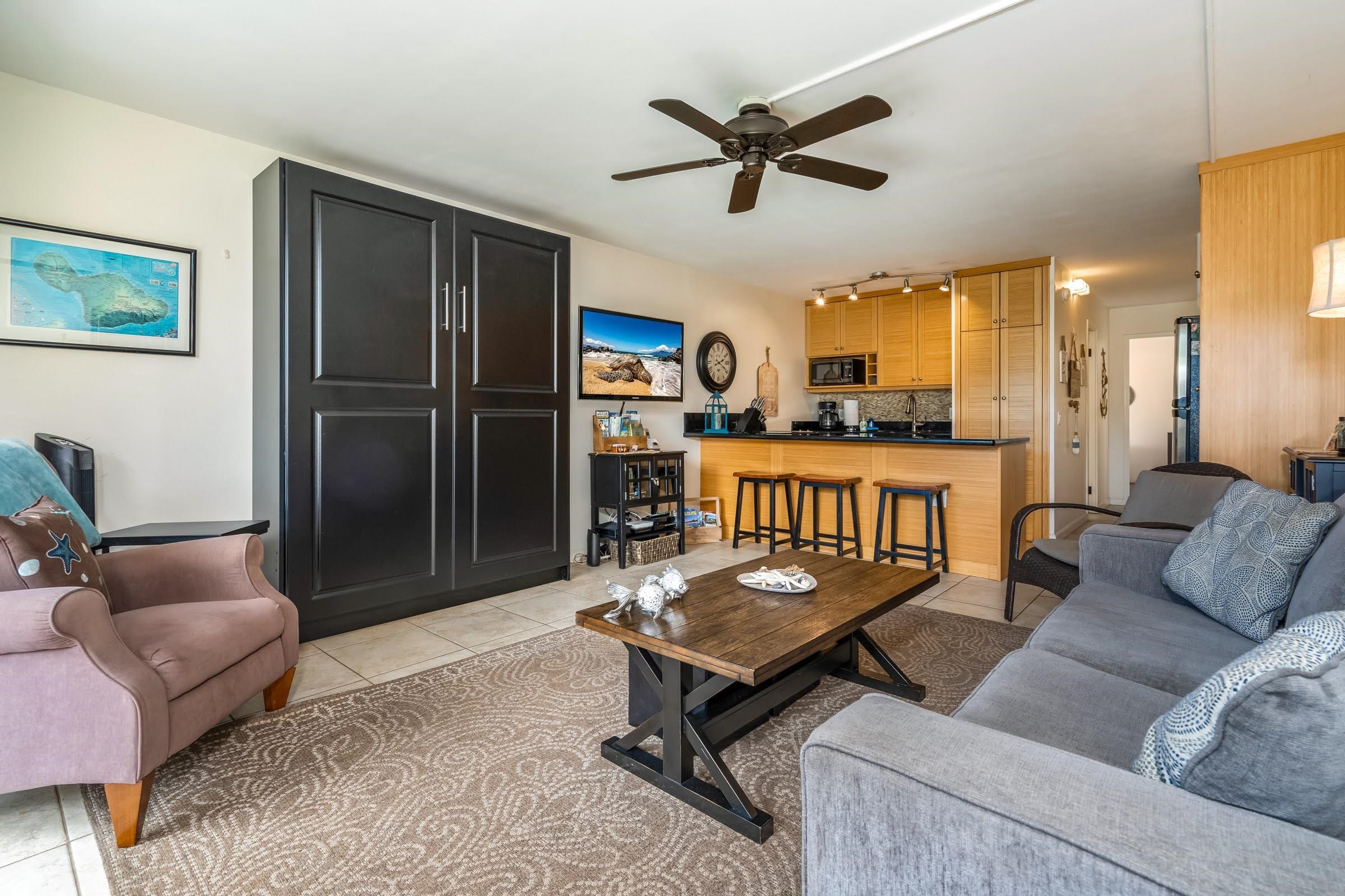 2191 South Kihei Road, Unit 1110 Kihei, HI 96753 - Photo 2 of 20 a living room with furniture and a flat screen tv