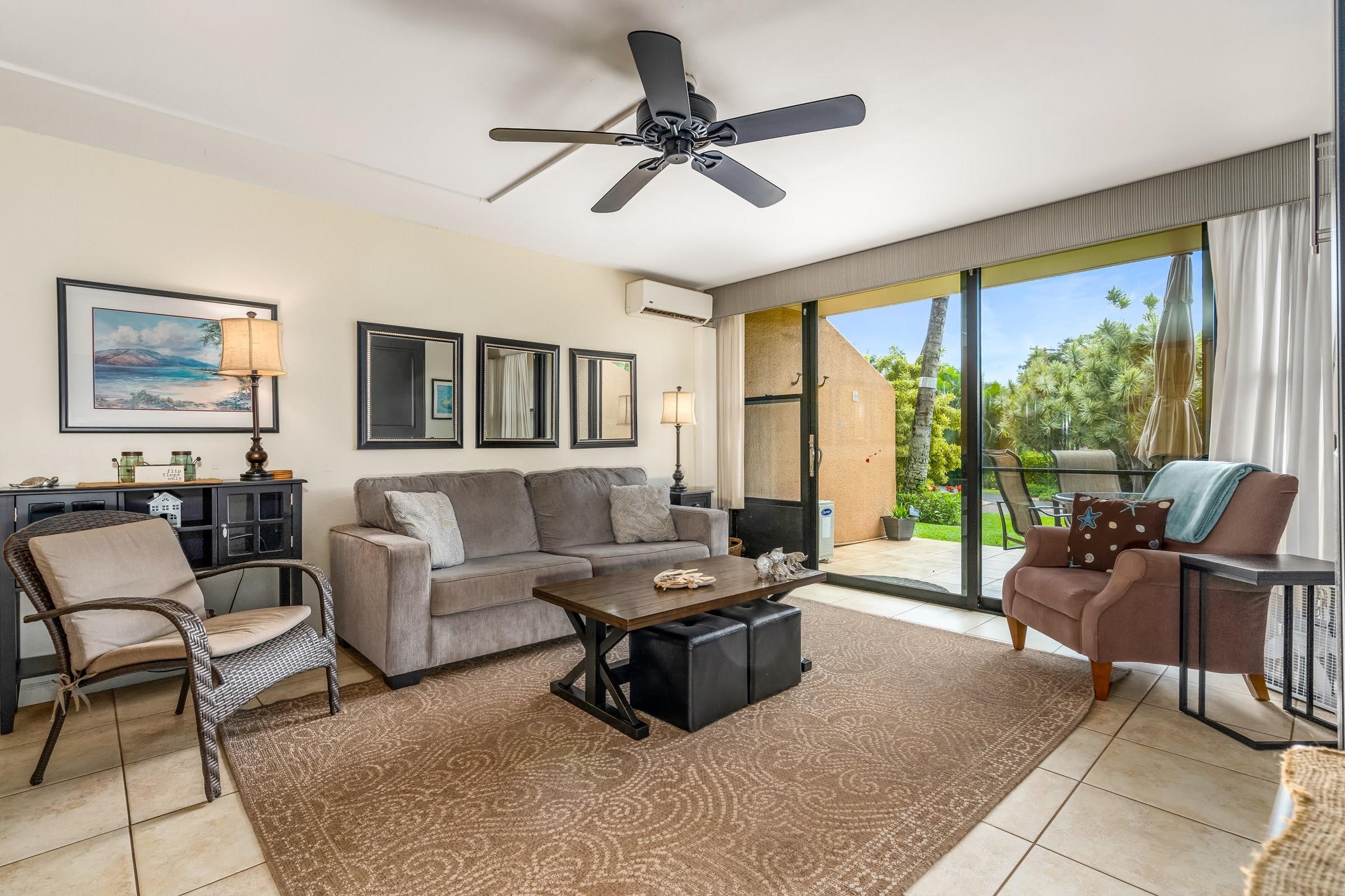 2191 South Kihei Road, Unit 1110 Kihei, HI 96753 - Photo 5 of 20 a living room with furniture and floor to ceiling windows