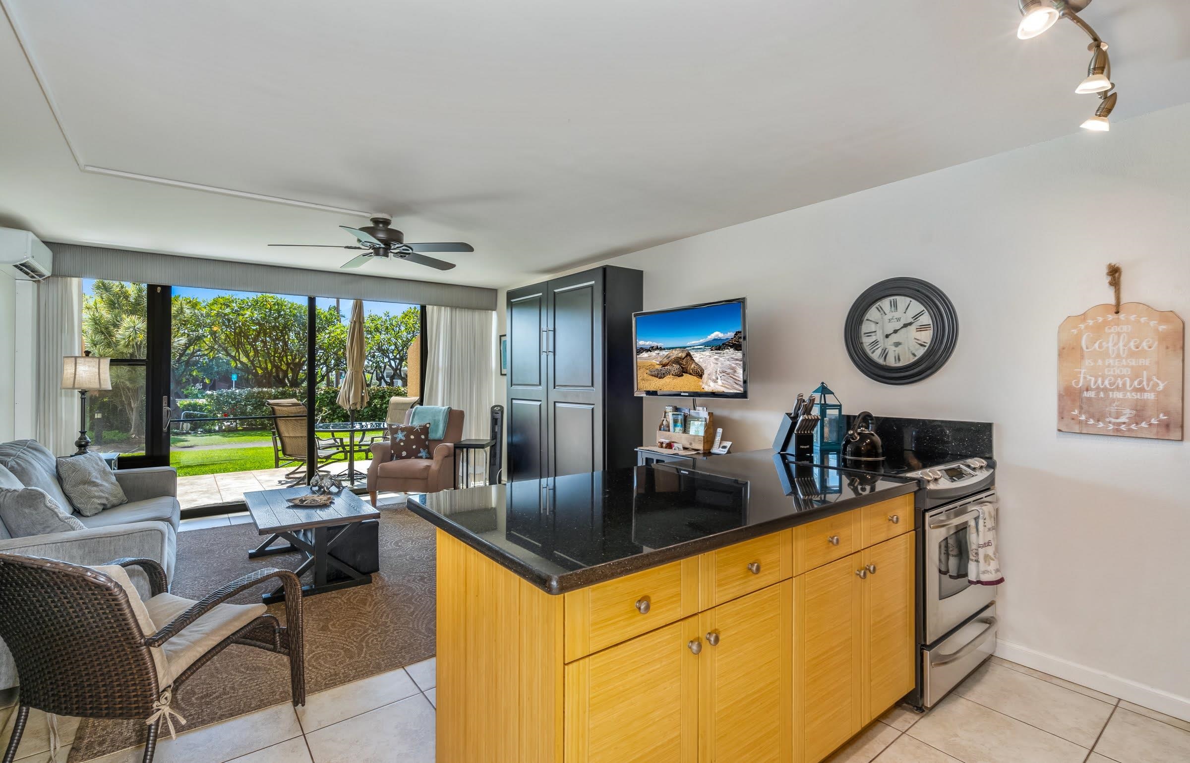 2191 South Kihei Road, Unit 1110 Kihei, HI 96753 - Photo 8 of 20 a view of a kitchen with a dining table and chairs