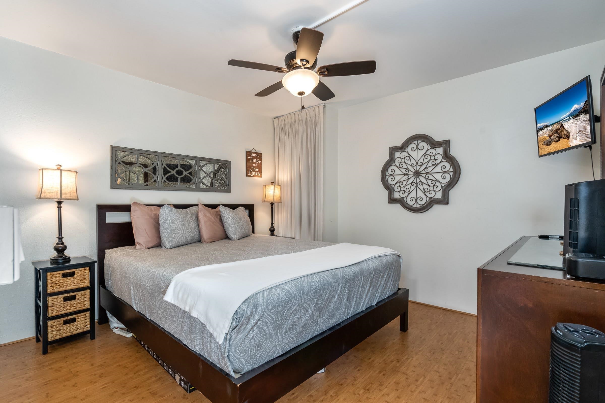 2191 South Kihei Road, Unit 1110 Kihei, HI 96753 - Photo 10 of 20 a bedroom with a bed and a chandelier