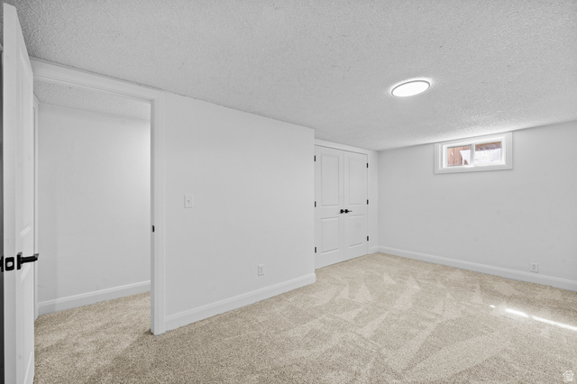 2267 West 4350th Street South Roy, UT 84067 - Photo 25 of 32 Below grade area with light carpet and a textured ceiling