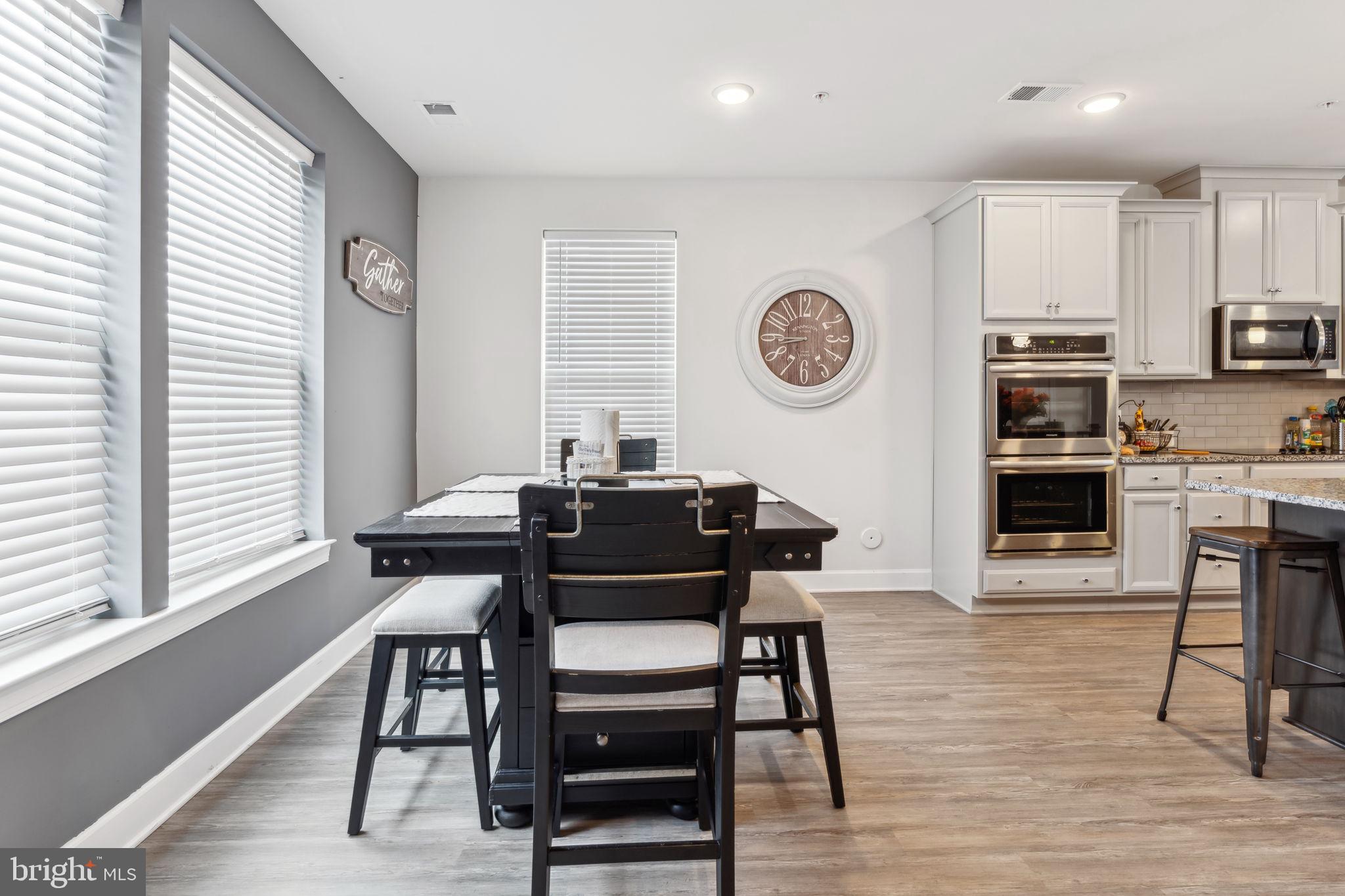 7635 Stemhart Lane Hanover, MD 21076 - Photo 12 of 28 a view of a dining room with furniture and a large window