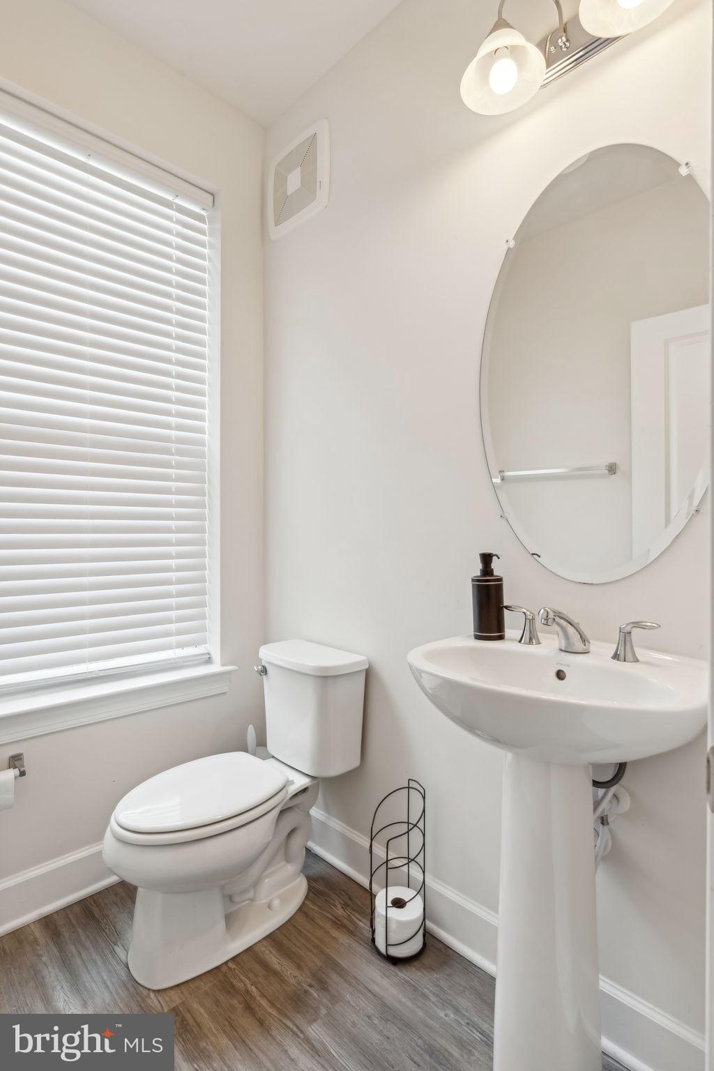 7635 Stemhart Lane Hanover, MD 21076 - Photo 16 of 28 a white toilet sitting next to a bathroom sink