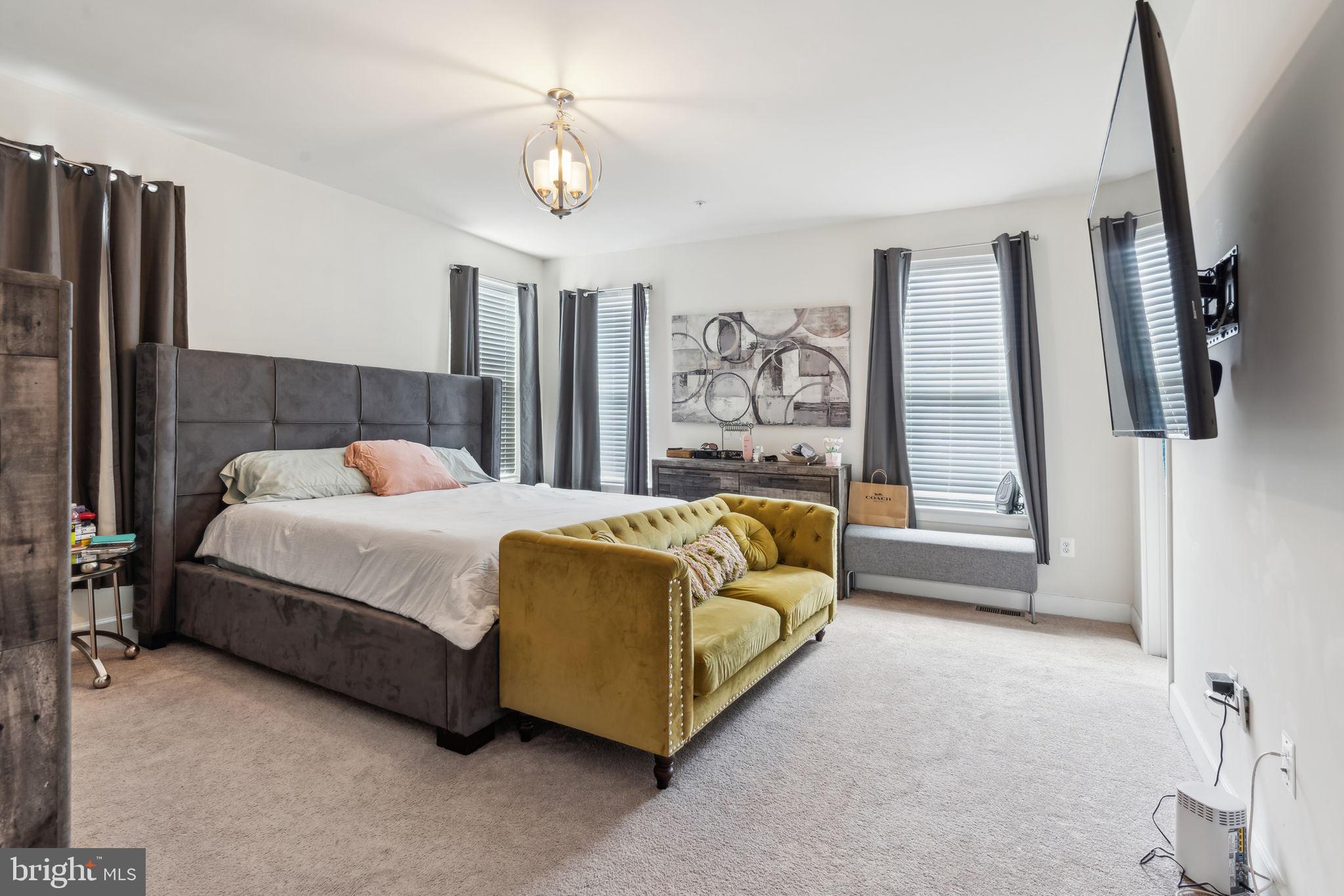 7635 Stemhart Lane Hanover, MD 21076 - Photo 17 of 28 a bed sitting in a spacious bedroom next to a window