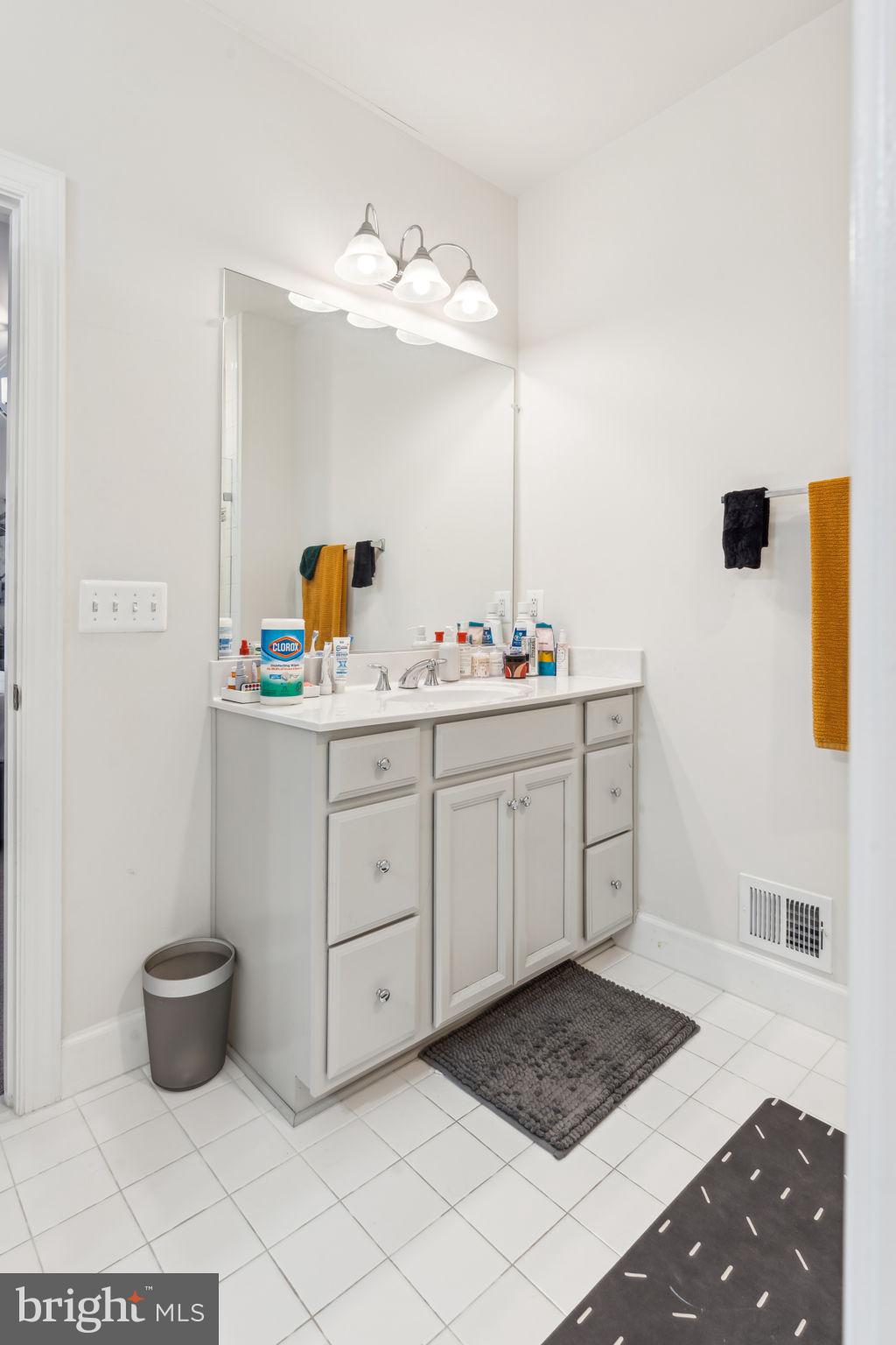 7635 Stemhart Lane Hanover, MD 21076 - Photo 19 of 28 a spacious bathroom with a sink and a mirror