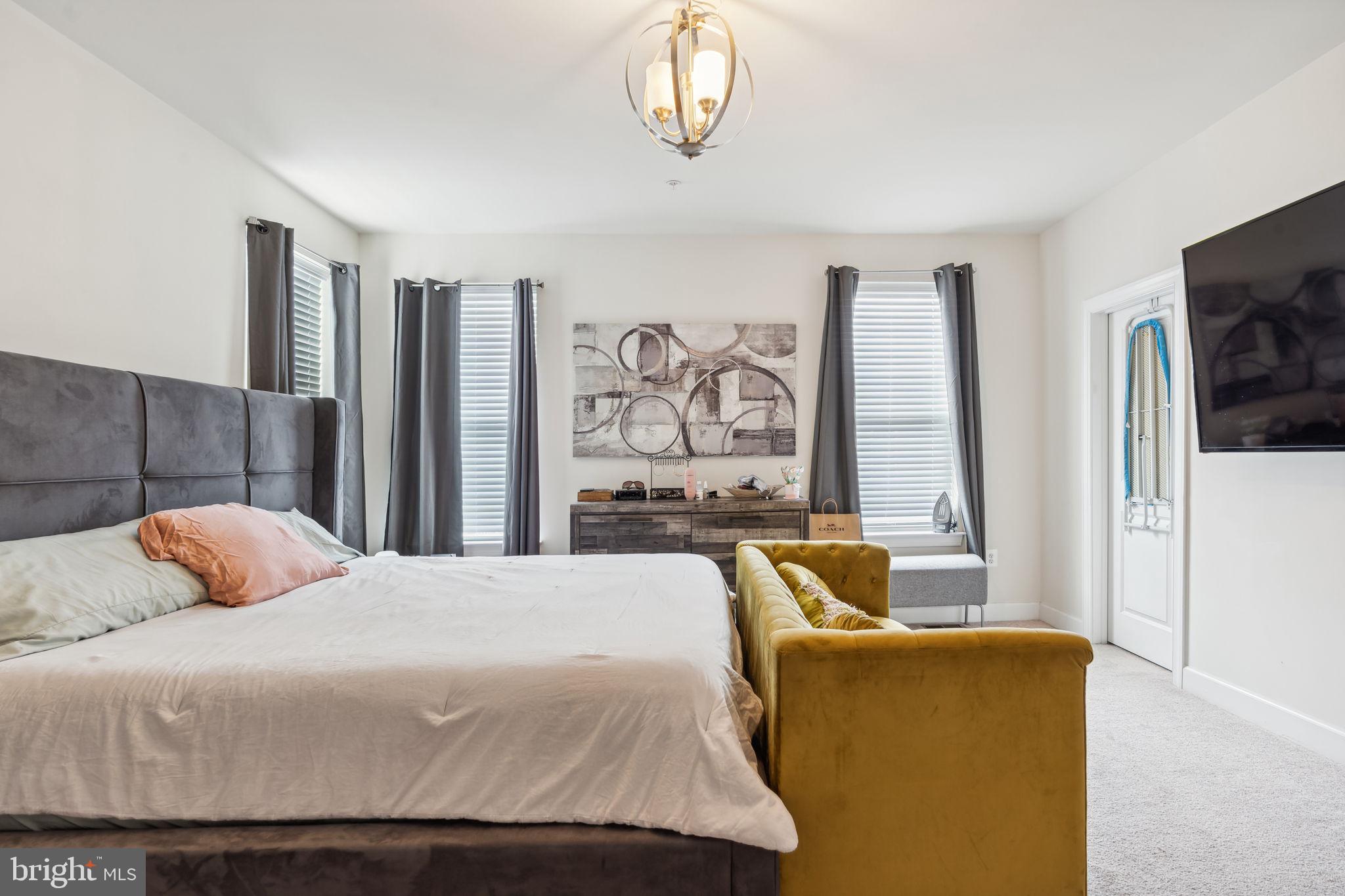 7635 Stemhart Lane Hanover, MD 21076 - Photo 20 of 28 a bedroom with furniture and a flat screen tv