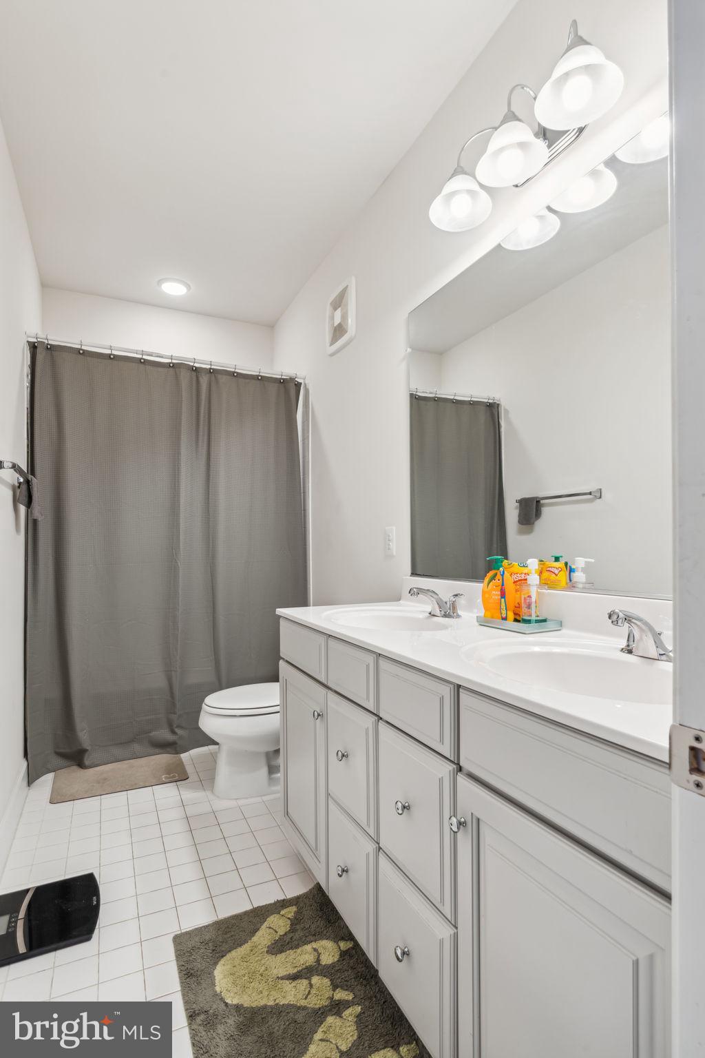 7635 Stemhart Lane Hanover, MD 21076 - Photo 22 of 28 a bathroom with a sink a toilet and a mirror